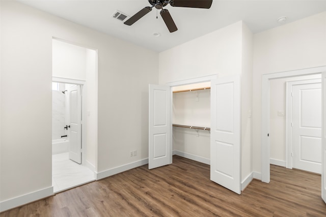 unfurnished bedroom featuring wood-type flooring, a closet, and ceiling fan