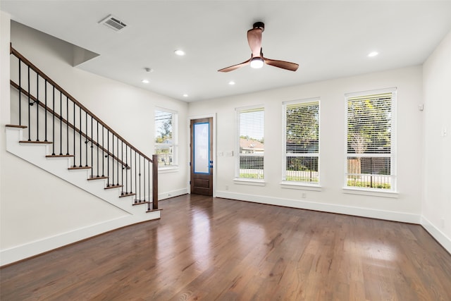 foyer featuring a wealth of natural light, ceiling fan, and dark wood-type flooring