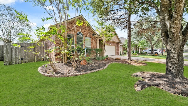 view of front of home featuring a front lawn and a garage