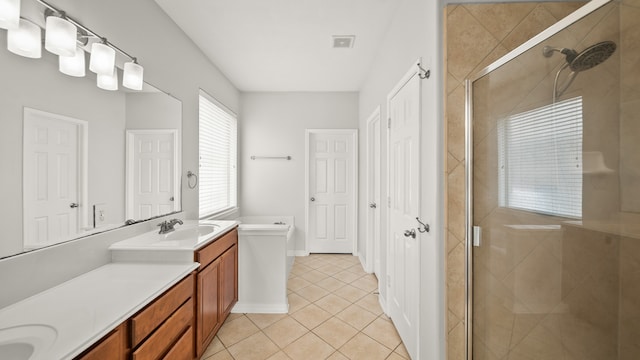 bathroom featuring walk in shower, vanity, and tile patterned flooring