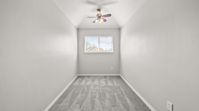 carpeted spare room featuring lofted ceiling and ceiling fan