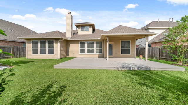 rear view of property featuring a lawn and a patio area