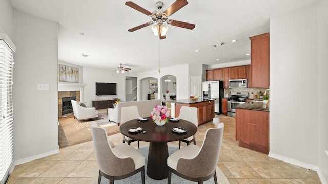 tiled dining area featuring ceiling fan