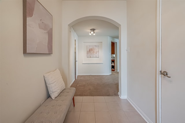 hallway featuring light colored carpet