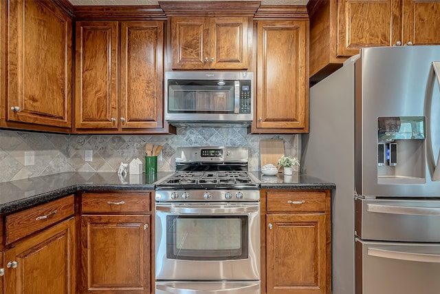 kitchen featuring dark stone counters, decorative backsplash, and stainless steel appliances