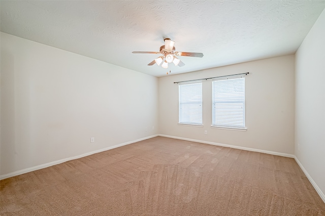 unfurnished room featuring a textured ceiling, carpet flooring, and ceiling fan