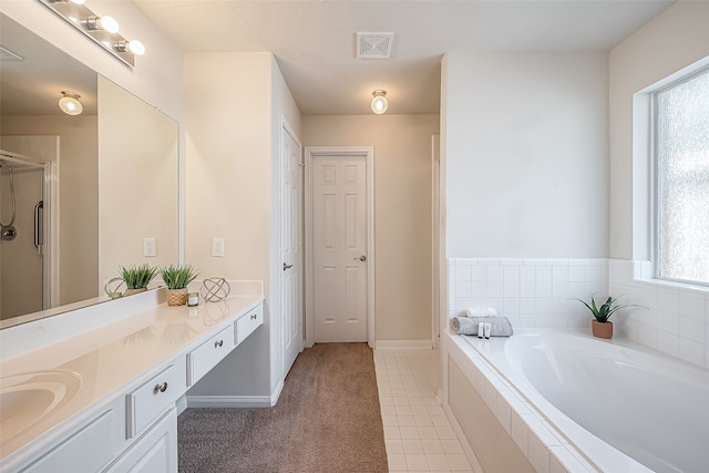 bathroom featuring independent shower and bath, vanity, and tile patterned floors