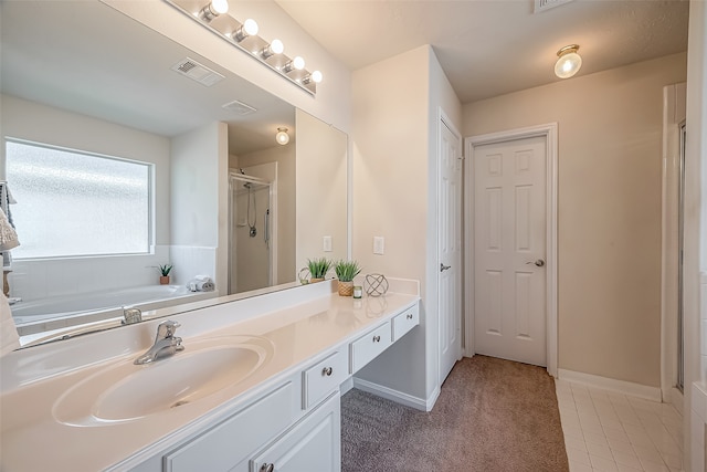 bathroom with vanity, tile patterned floors, and separate shower and tub