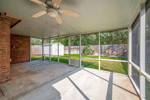 unfurnished sunroom featuring ceiling fan