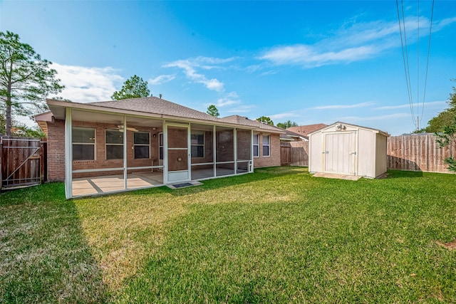 back of property featuring a patio area, a yard, ceiling fan, and a storage unit