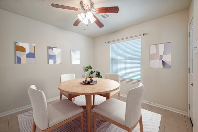 tiled dining room featuring ceiling fan