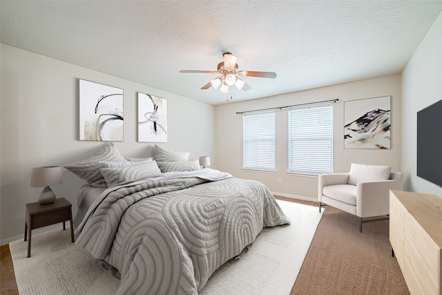 carpeted bedroom with a textured ceiling and ceiling fan