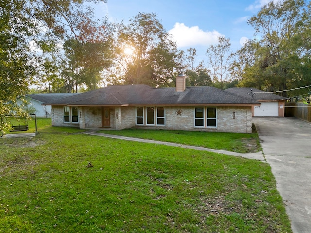 rear view of house with a lawn and a garage