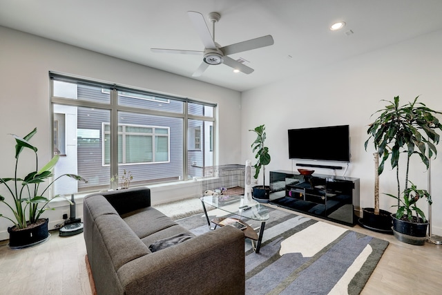 living room featuring light hardwood / wood-style floors and ceiling fan