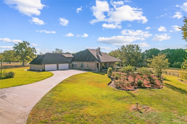 single story home featuring a garage and a front yard