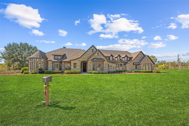 tudor-style house featuring a front lawn