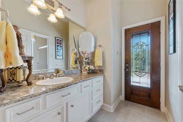 bathroom with vanity, a shower with door, and tile patterned flooring