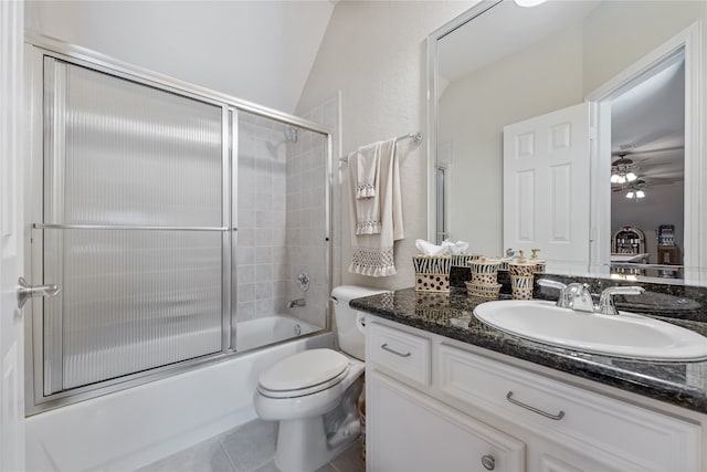 full bathroom featuring tile patterned floors, shower / bath combination with glass door, vanity, vaulted ceiling, and toilet