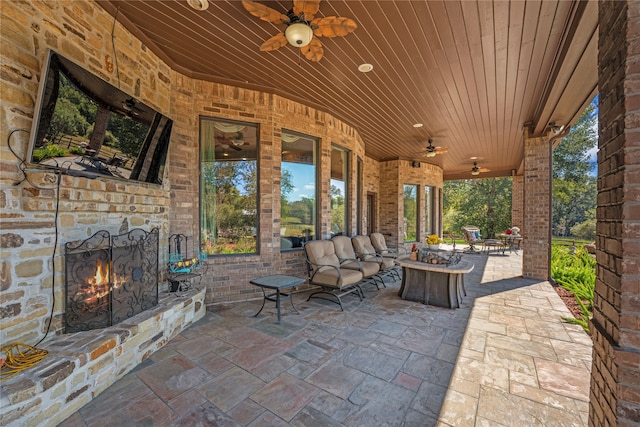 view of patio / terrace with a fire pit and ceiling fan