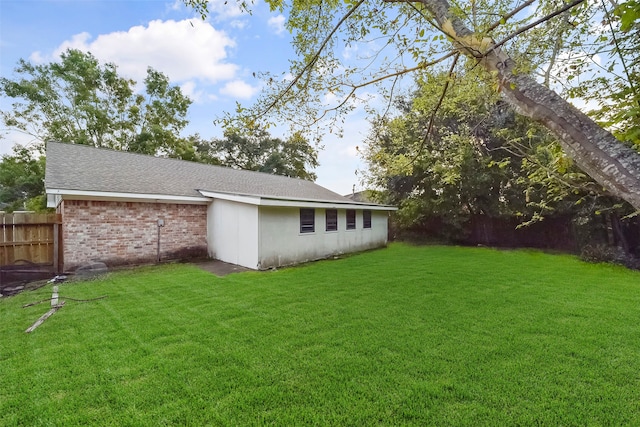 rear view of property featuring a yard