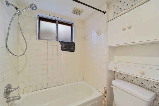 bathroom featuring tiled shower / bath and toilet