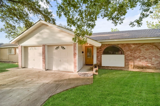 ranch-style home with a garage and a front lawn