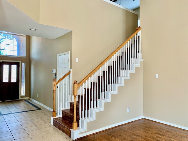 entryway featuring light wood-type flooring and a high ceiling