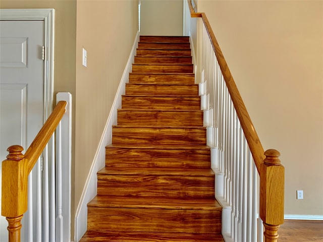 staircase with hardwood / wood-style flooring