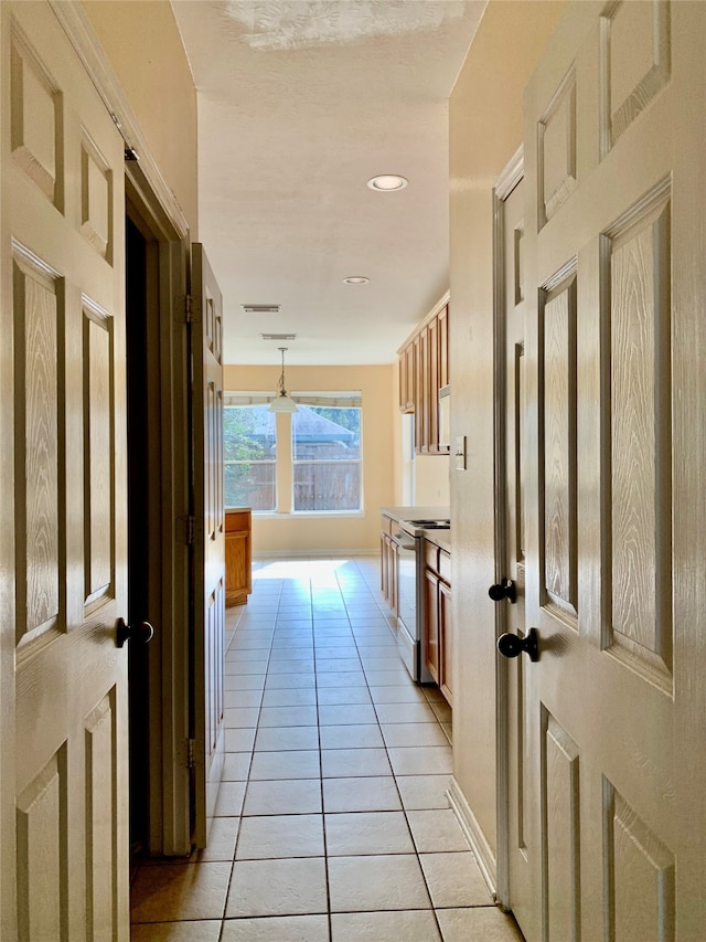 corridor with light tile patterned floors