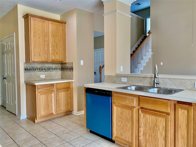 kitchen with sink, light tile patterned floors, stainless steel dishwasher, ornate columns, and decorative backsplash