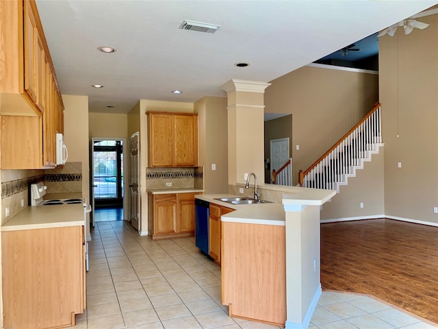 kitchen featuring sink, backsplash, white appliances, light hardwood / wood-style flooring, and ornate columns