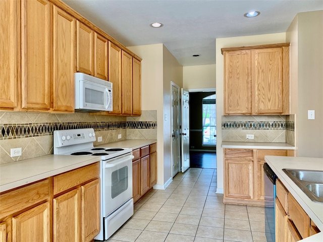 kitchen featuring white appliances, sink, light tile patterned flooring, and tasteful backsplash