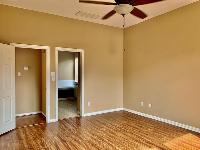 empty room featuring ceiling fan and light hardwood / wood-style flooring