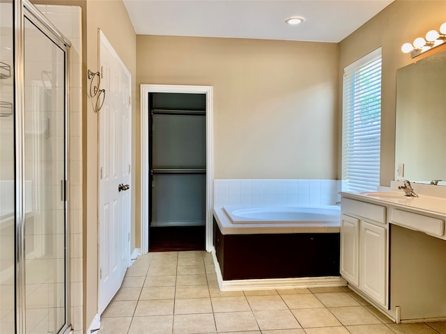 bathroom with vanity, tile patterned flooring, and separate shower and tub