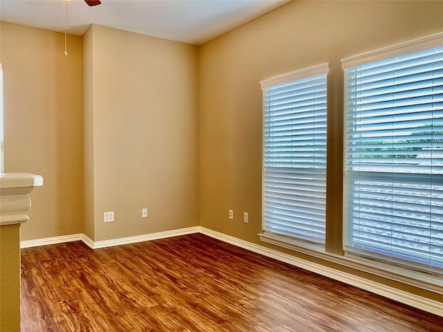 spare room with wood-type flooring and ceiling fan