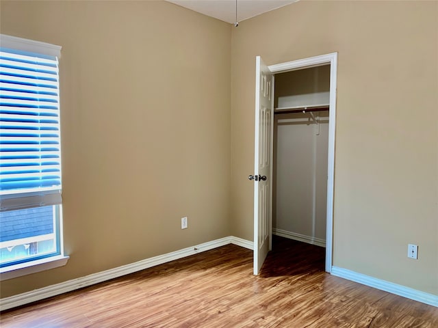 unfurnished bedroom featuring a closet and light wood-type flooring