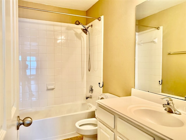 full bathroom featuring vanity, tiled shower / bath combo, and toilet