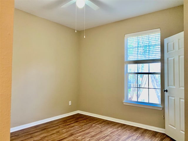 empty room featuring hardwood / wood-style flooring and ceiling fan