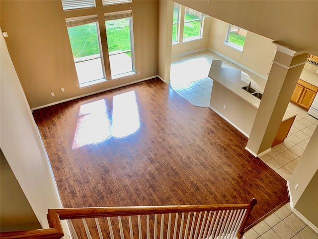 interior space featuring decorative columns and light tile patterned flooring