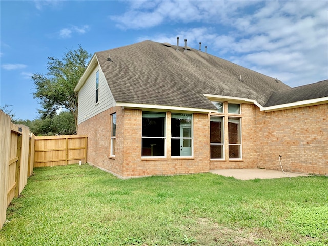 back of property featuring a yard and a patio area