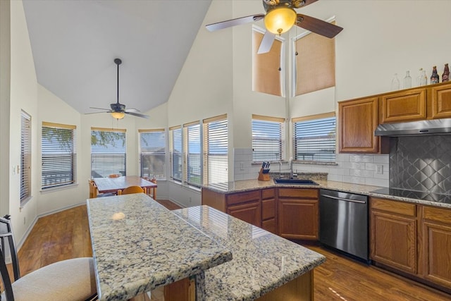 kitchen with dishwasher, a kitchen island, dark wood-type flooring, and sink