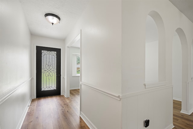 foyer with hardwood / wood-style floors and a textured ceiling