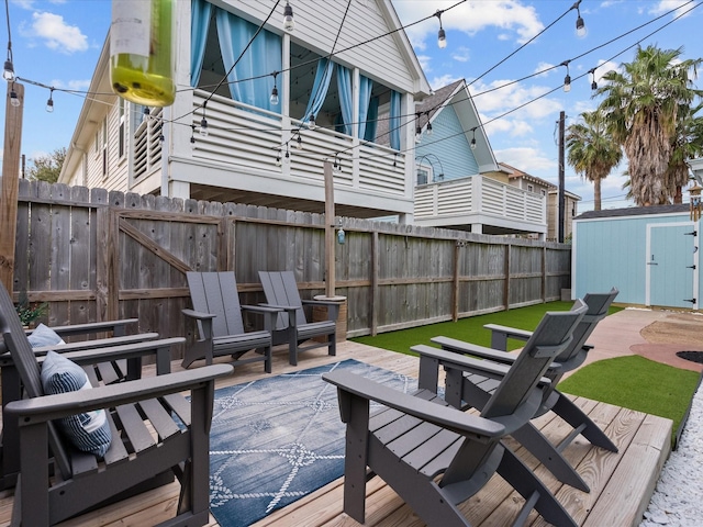 deck featuring a patio area and a shed