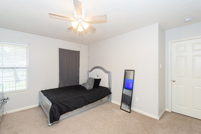 bedroom with light colored carpet and ceiling fan