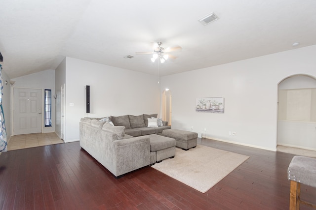 living room with dark wood-type flooring, vaulted ceiling, and ceiling fan