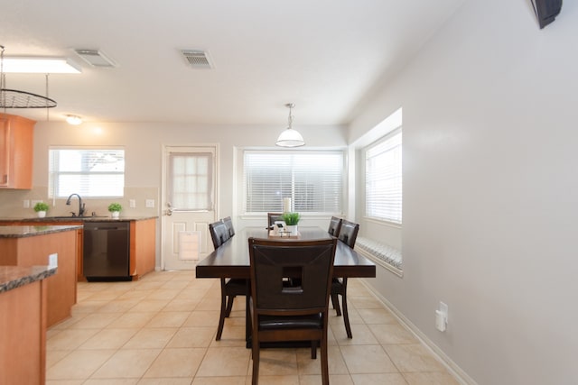 tiled dining space featuring sink