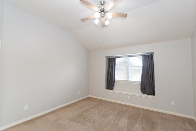 carpeted empty room featuring lofted ceiling and ceiling fan