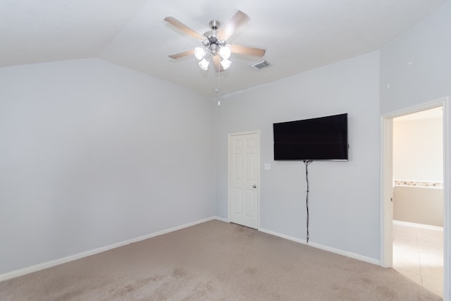 unfurnished bedroom with light colored carpet, ceiling fan, and vaulted ceiling