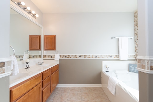 bathroom featuring a tub to relax in, vanity, and tile patterned flooring