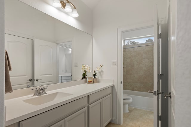 full bathroom with toilet, vanity, tile patterned floors, and tiled shower / bath combo